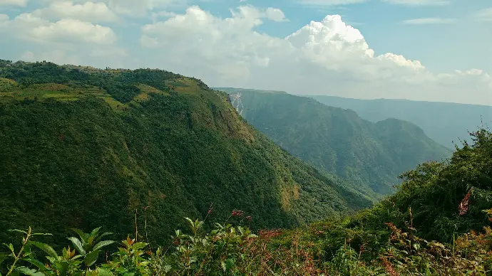 green mountain under white clouds during daytime